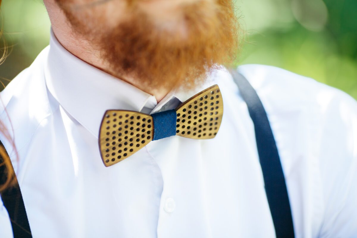 wooden bow tie put over the white shirt under red beard