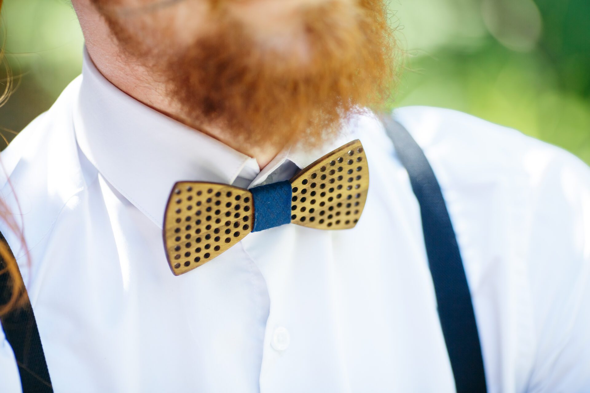 wooden bow tie put over the white shirt under red beard
