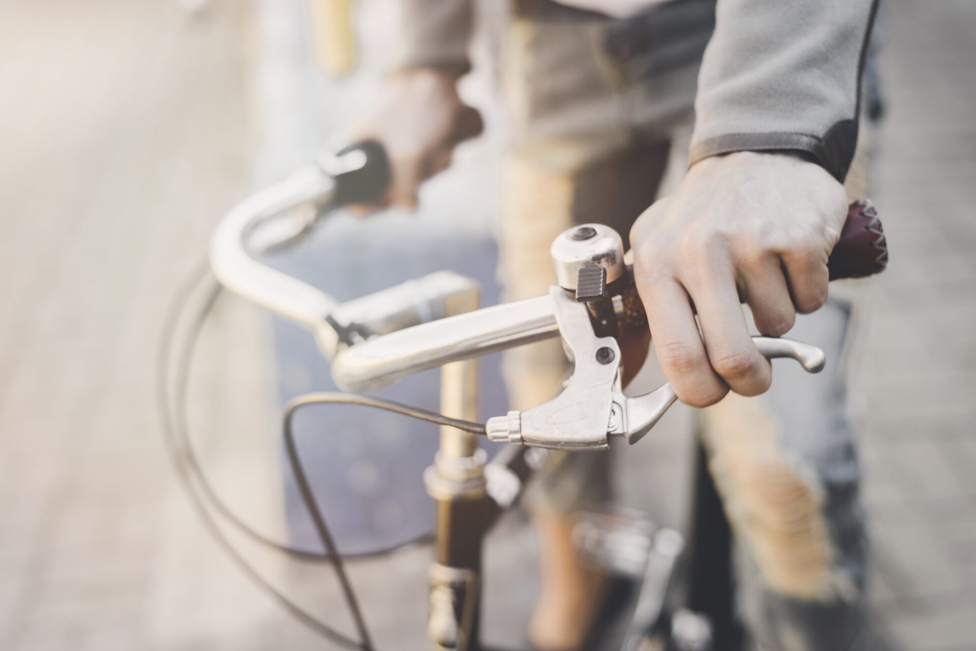 man s hand pressing bicycle brake